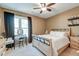 Cozy bedroom features neutral walls, large window with dark drapes, ceiling fan and a comfortable bed at 2434 Egret Crest Ln, Charleston, SC 29414