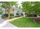 Inviting clubhouse with lush landscaping and a paved walkway leading to a refreshing community pool area at 2434 Egret Crest Ln, Charleston, SC 29414