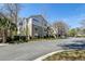 Exterior view of modern apartment complex with well-maintained landscaping, blue sky, and a paved street at 2434 Egret Crest Ln, Charleston, SC 29414