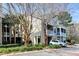 Exterior view of condo building featuring multiple stories, screened porch, and mature landscaping at 2434 Egret Crest Ln, Charleston, SC 29414
