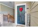 Charming front entrance with a black door, heart-shaped wreath, and welcome sign at 2434 Egret Crest Ln, Charleston, SC 29414