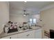 Open-concept kitchen featuring stainless steel sink and view to a living area with a ceiling fan at 2434 Egret Crest Ln, Charleston, SC 29414