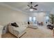 Cozy living room showcasing a plush sectional couch, ceiling fan, and access to a dining area at 2434 Egret Crest Ln, Charleston, SC 29414