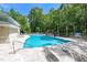 Large community pool surrounded by lounge chairs and lush trees at 2434 Egret Crest Ln, Charleston, SC 29414