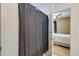Bathroom showcasing a shower with clear sliding doors, white tile, and a view into an adjacent bedroom at 2434 Egret Crest Ln, Charleston, SC 29414