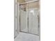 Clean bathroom featuring a shower with sliding glass doors, bright lighting, and white tile at 2434 Egret Crest Ln, Charleston, SC 29414