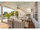 A covered patio area offers ample seating, ceiling fan, exterior stairs and access to the pool at 2529 Atlantic Ave, Sullivans Island, SC 29482