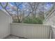 A private balcony with a white fence offering natural lighting and surrounding trees at 2765 Jobee Dr # 1303, Charleston, SC 29414