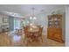 Cozy dining area with wood table and chairs next to a living space with natural lighting at 2765 Jobee Dr # 1303, Charleston, SC 29414