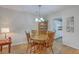 Inviting dining area with wood table, chairs, chandelier, and view into the adjacent kitchen at 2765 Jobee Dr # 1303, Charleston, SC 29414