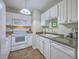 Well-maintained kitchen featuring white appliances, cabinets, modern fixtures, and easy to clean tile floors at 2765 Jobee Dr # 1303, Charleston, SC 29414