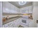 Well-lit kitchen featuring white appliances, ample cabinets, and plenty of counter space for cooking at 2765 Jobee Dr # 1303, Charleston, SC 29414