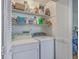 Functional laundry area with washer, dryer, and storage shelving at 2765 Jobee Dr # 1303, Charleston, SC 29414