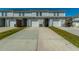 Row of townhome garages with white doors and driveways, showcasing the home's parking convenience at 286 Godwit Dr, Summerville, SC 29486