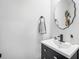 Stylish half bathroom with a vessel sink, sleek black fixtures, and decorative accents at 286 Godwit Dr, Summerville, SC 29486