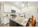 Well-lit kitchen with white cabinets, granite countertops, stainless appliances, and a kitchen island with breakfast bar at 286 Godwit Dr, Summerville, SC 29486