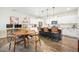 Open kitchen and dining area with island seating, stainless appliances, and an adjacent desk and workspace at 286 Godwit Dr, Summerville, SC 29486