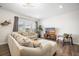 Comfortable living room with a large sectional sofa, accent chair, and a bright window with neighborhood views at 286 Godwit Dr, Summerville, SC 29486