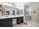 Well-lit main bathroom featuring double sinks, and a glass-enclosed shower at 286 Godwit Dr, Summerville, SC 29486