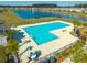 Aerial view of a community pool featuring lounge chairs and a beautiful pond and single Gathering homes at 286 Godwit Dr, Summerville, SC 29486