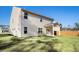 View of the home's backyard and covered patio, featuring lush green grass and a privacy fence at 294 Torslanda Ln, Summerville, SC 29486
