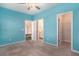 Cozy bedroom with blue walls, neutral carpet, ceiling fan and featuring a closet and bathroom nearby at 294 Torslanda Ln, Summerville, SC 29486