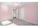 Pink bedroom with a ceiling fan, closet, and hallway access at 294 Torslanda Ln, Summerville, SC 29486