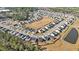 Aerial view of the neighborhood showcasing a Gathering-friendly community with a tranquil pond and manicured landscaping at 294 Torslanda Ln, Summerville, SC 29486