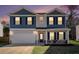 Inviting two-story home showcasing blue and beige siding, complemented by a well-manicured lawn and attached garage at 294 Torslanda Ln, Summerville, SC 29486