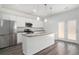Modern kitchen featuring stainless steel appliances, granite countertops, white cabinets, and hardwood flooring at 294 Torslanda Ln, Summerville, SC 29486