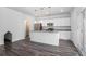 Modern kitchen with white cabinets, granite countertops, stainless steel appliances, and hardwood floors at 294 Torslanda Ln, Summerville, SC 29486