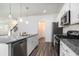 Bright kitchen with granite countertops, stainless steel appliances, white cabinets, and hardwood floors at 294 Torslanda Ln, Summerville, SC 29486