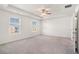 Spacious main bedroom with plush carpet, tray ceilings, and large windows providing ample natural light at 294 Torslanda Ln, Summerville, SC 29486