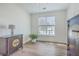 A sunlit bedroom featuring a traditional wood cabinet with stylish design and hardwood floors at 2978 Sweetleaf Ln, Johns Island, SC 29455