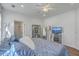 Spacious main bedroom with large windows, a ceiling fan, and a view of the en-suite bathroom at 2978 Sweetleaf Ln, Johns Island, SC 29455