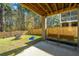 Covered patio with swing and bench seating overlooks the backyard and fire pit, perfect for relaxing at 312 Coki Amalie Ct, Charleston, SC 29492