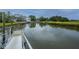 View of a dock leading to a backyard featuring a bright house and lush foliage at 312 Coki Amalie Ct, Charleston, SC 29492