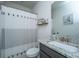 Bright bathroom featuring a granite vanity, framed art, and a shower with patterned curtain at 312 Coki Amalie Ct, Charleston, SC 29492
