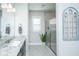 Bathroom featuring a granite countertop sink, a glass-enclosed shower, and a decorative window frame at 312 Coki Amalie Ct, Charleston, SC 29492