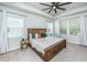 Spacious bedroom featuring a wooden bed frame, plush carpet, and a modern ceiling fan for enhanced comfort at 312 Coki Amalie Ct, Charleston, SC 29492
