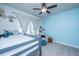 Charming bedroom featuring a cozy loft bed, a calming blue accent wall, and a ceiling fan at 312 Coki Amalie Ct, Charleston, SC 29492