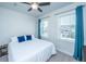 Cozy bedroom with a ceiling fan, bright windows, and blue curtains, offering comfort and natural light at 312 Coki Amalie Ct, Charleston, SC 29492