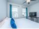 Inviting bedroom with a ceiling fan, bright windows, and blue pillows, providing comfort and natural light at 312 Coki Amalie Ct, Charleston, SC 29492