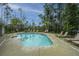 Inviting community pool with lounge chairs, umbrellas, and lush landscaping for residents to enjoy at 312 Coki Amalie Ct, Charleston, SC 29492
