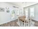 Cozy dining area with French doors to a deck, wood table and chairs, and natural light at 312 Coki Amalie Ct, Charleston, SC 29492