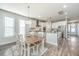 Dining area with a wooden table, white chairs, and ample natural light, located adjacent to the kitchen at 312 Coki Amalie Ct, Charleston, SC 29492