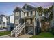 Charming two-story home features a welcoming porch and manicured front yard at dusk at 312 Coki Amalie Ct, Charleston, SC 29492