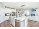 Open-concept kitchen with stainless steel appliances, island, granite countertops, flowing into living area at 312 Coki Amalie Ct, Charleston, SC 29492