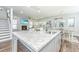 Close-up of the kitchen island showcasing the granite countertop and open floor plan to the living and dining areas at 312 Coki Amalie Ct, Charleston, SC 29492