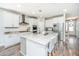 Bright kitchen with white cabinets, stainless steel appliances, and a large island with granite countertops at 312 Coki Amalie Ct, Charleston, SC 29492